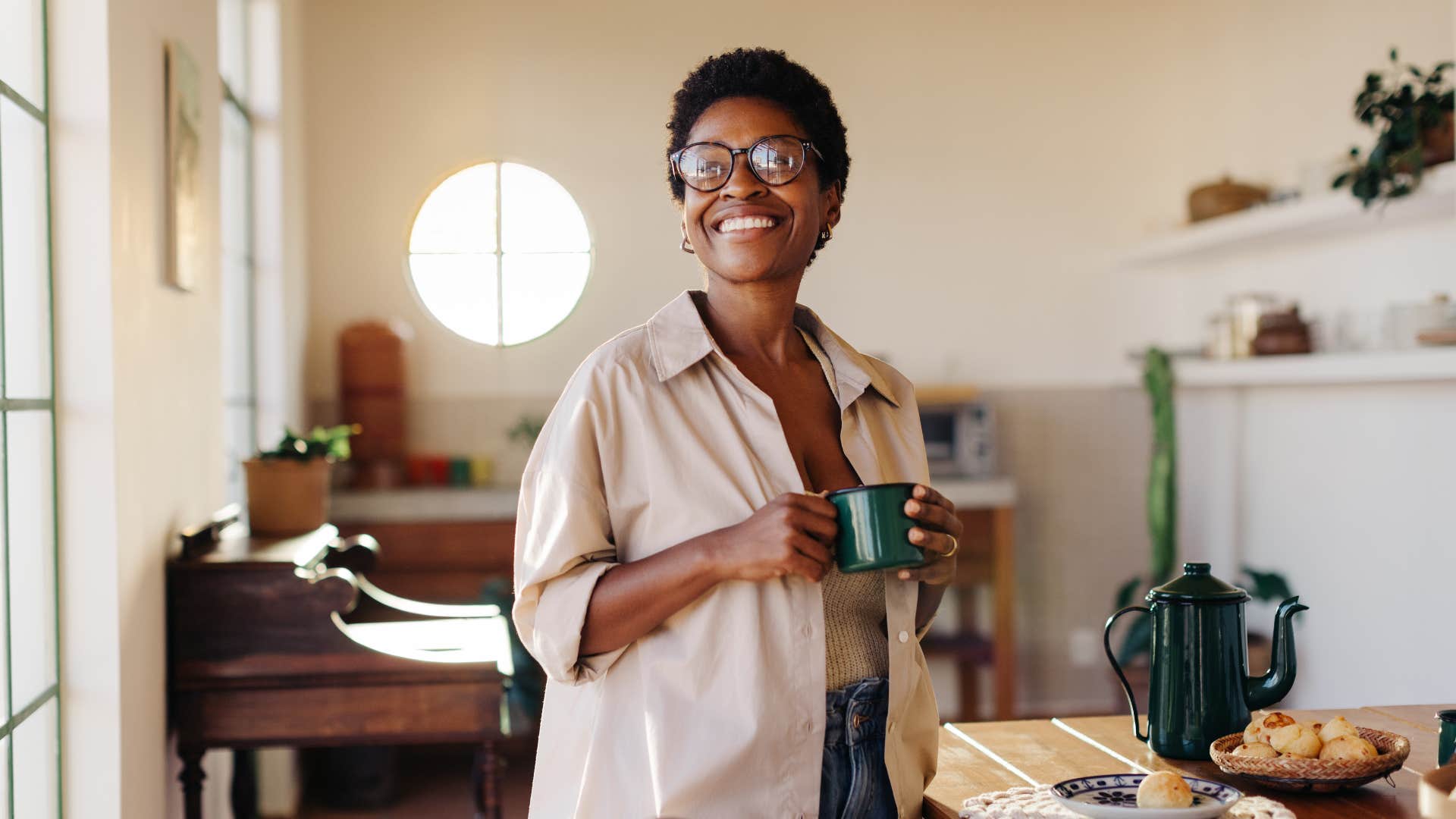 woman with a strong sense of responsibility smiling while drinking coffee