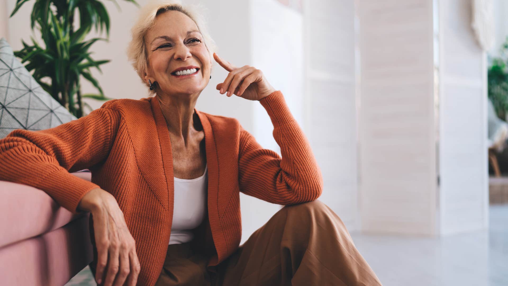 nostalgic woman sitting on the floor thinking