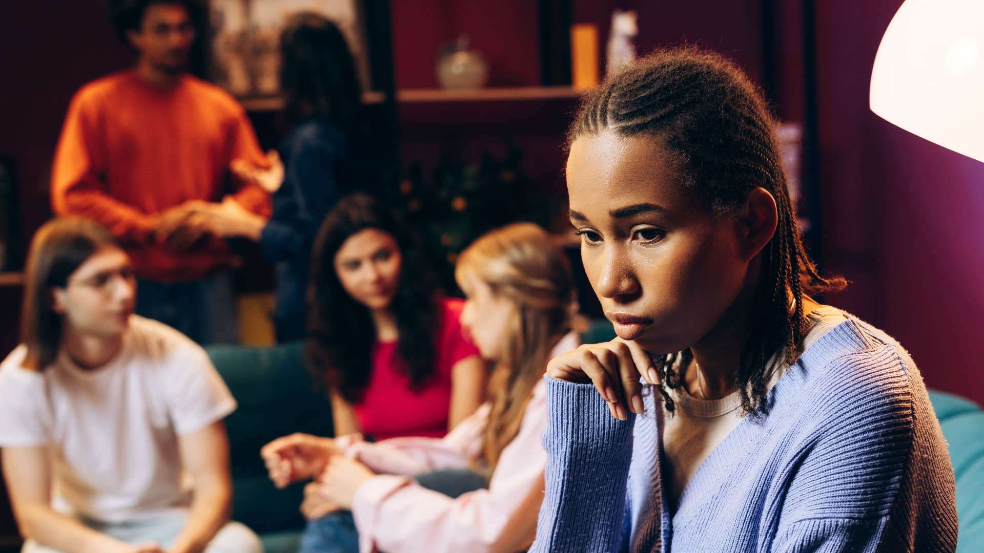 woman who doesn't want to feel left out sitting near friends