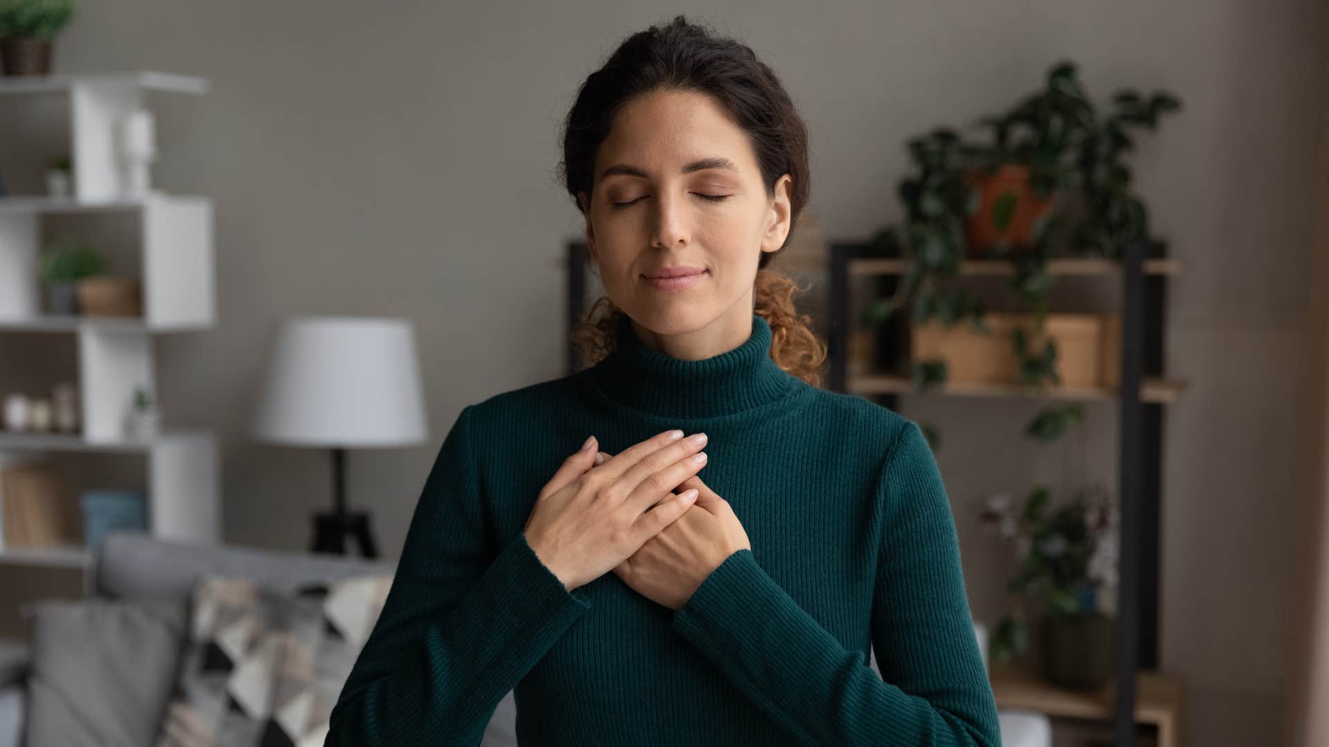 empathetic woman healing herself meditating