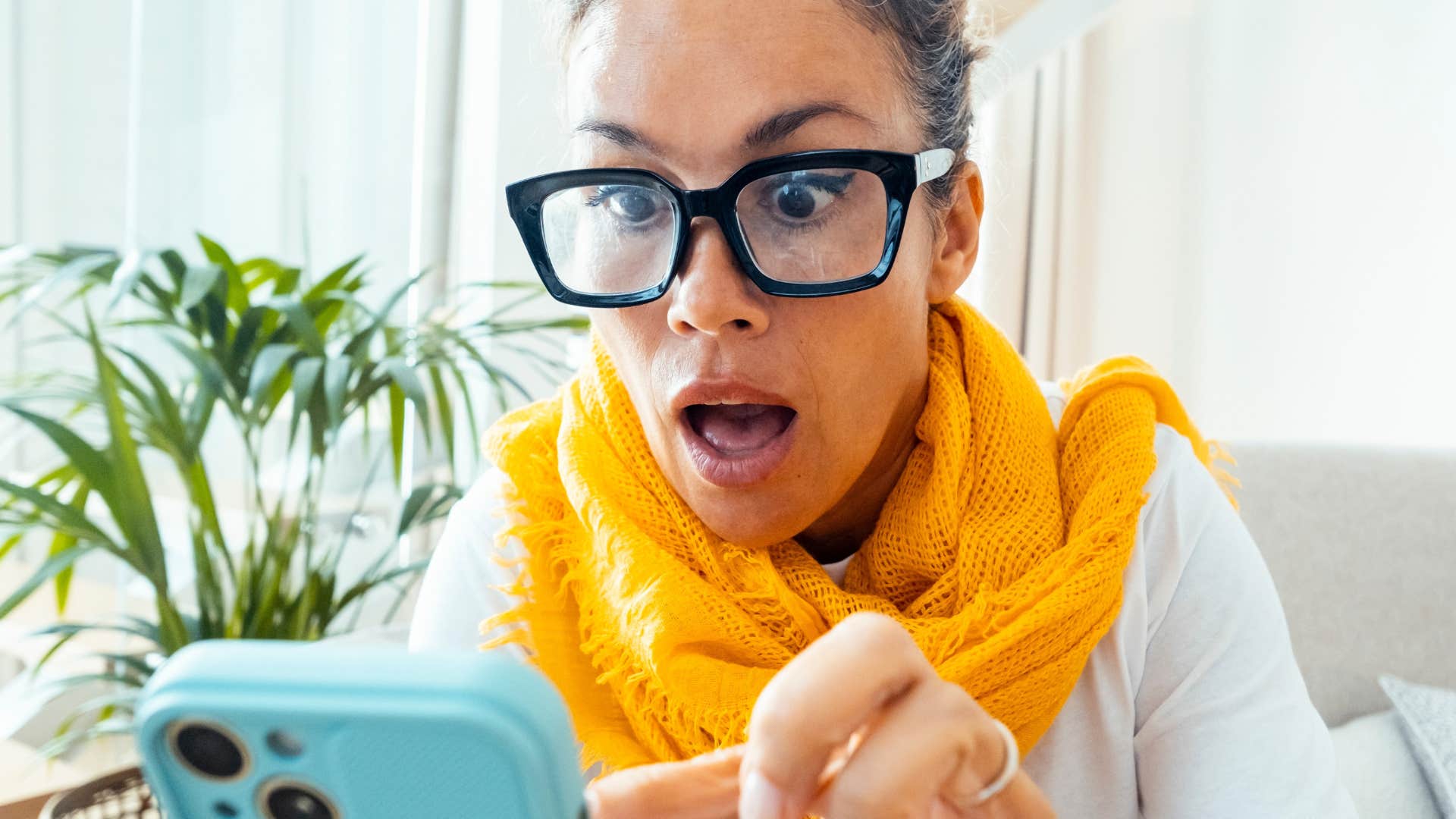 vigilant woman watching the news on her phone