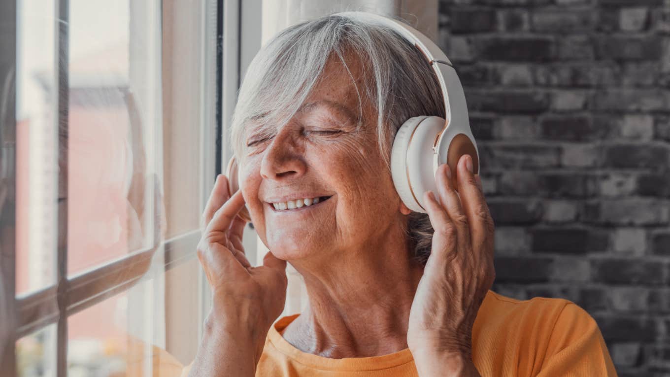 older woman listening to music with headphones