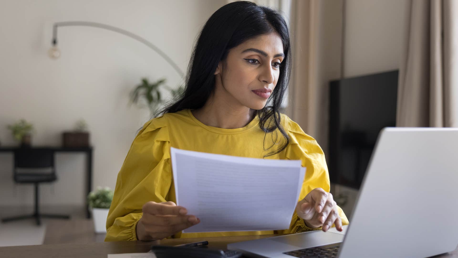 Detail-oriented woman working on her laptop.