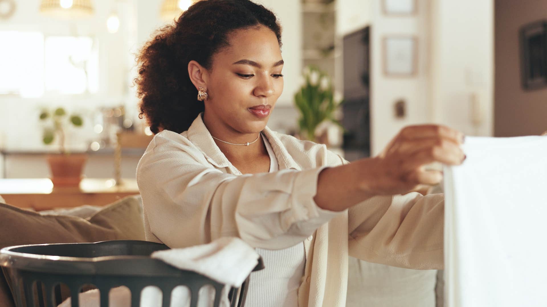 Disciplined woman doing laundry at home.