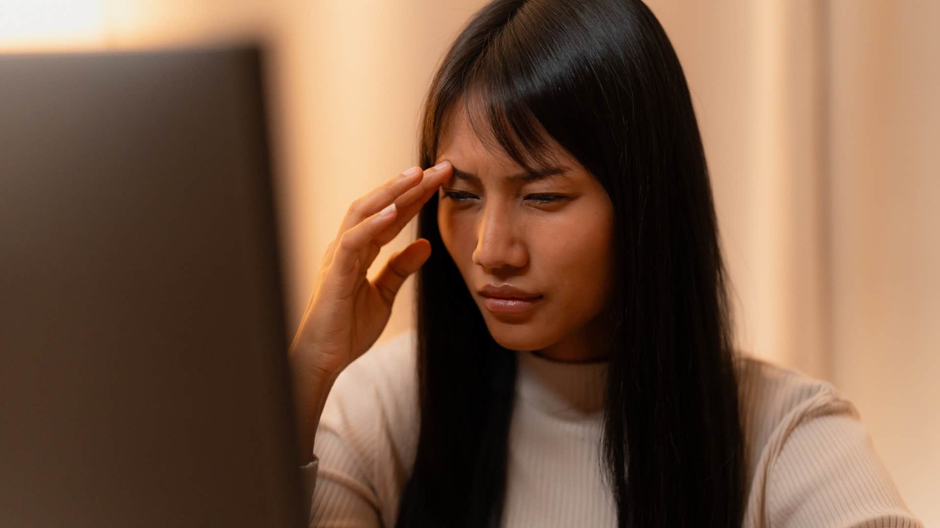 Woman who's a problem-solver at heart thinking at home.