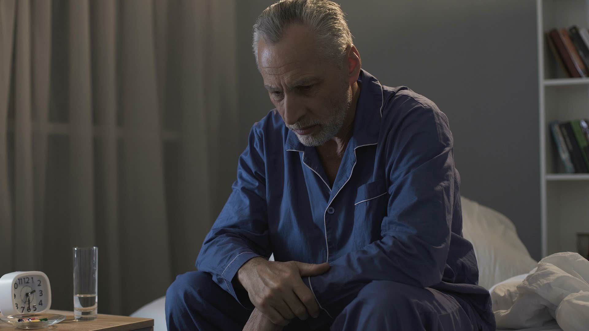 man waking up in the middle of the night with a stomach ache