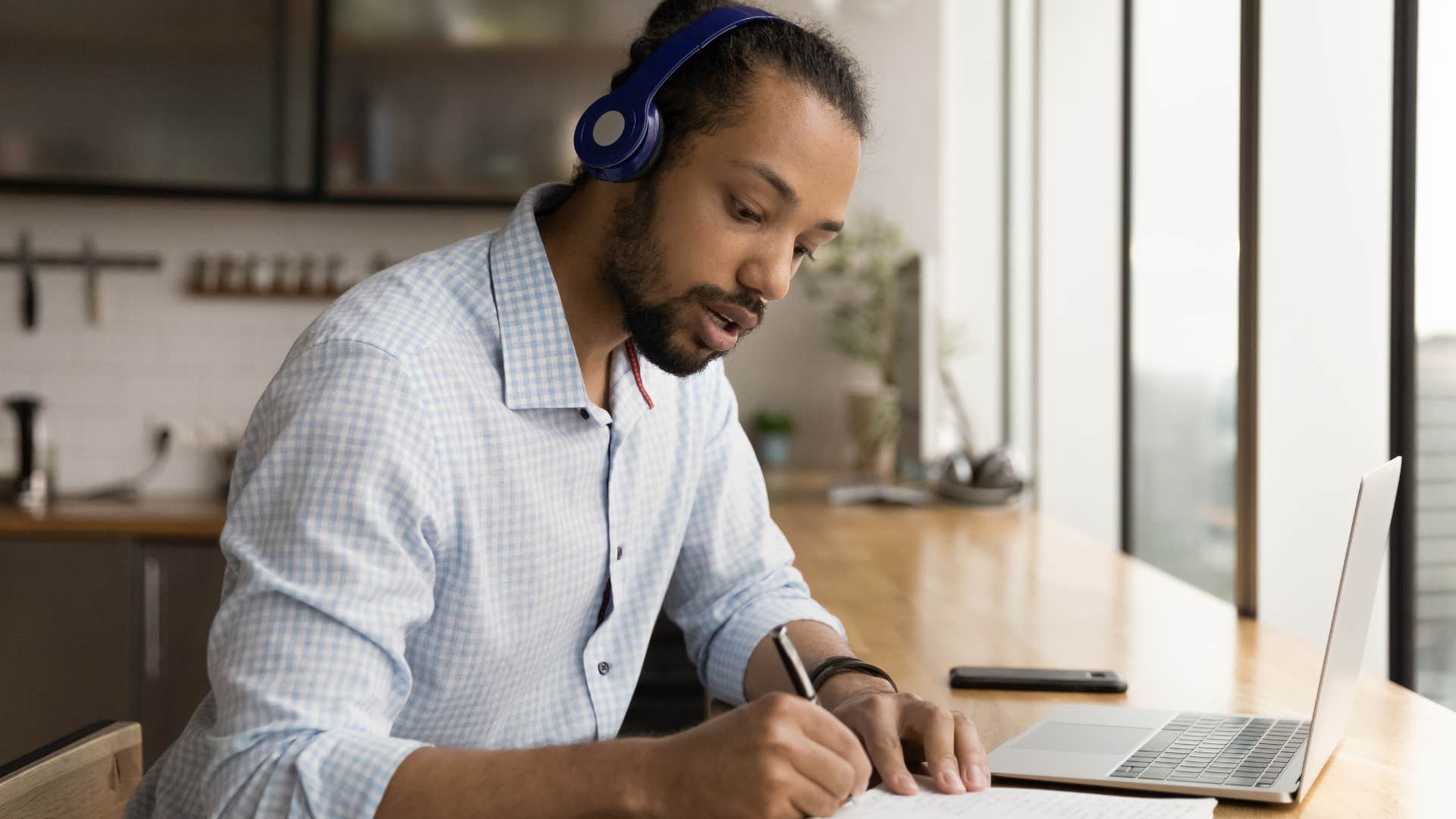 incredibly focused man working at home