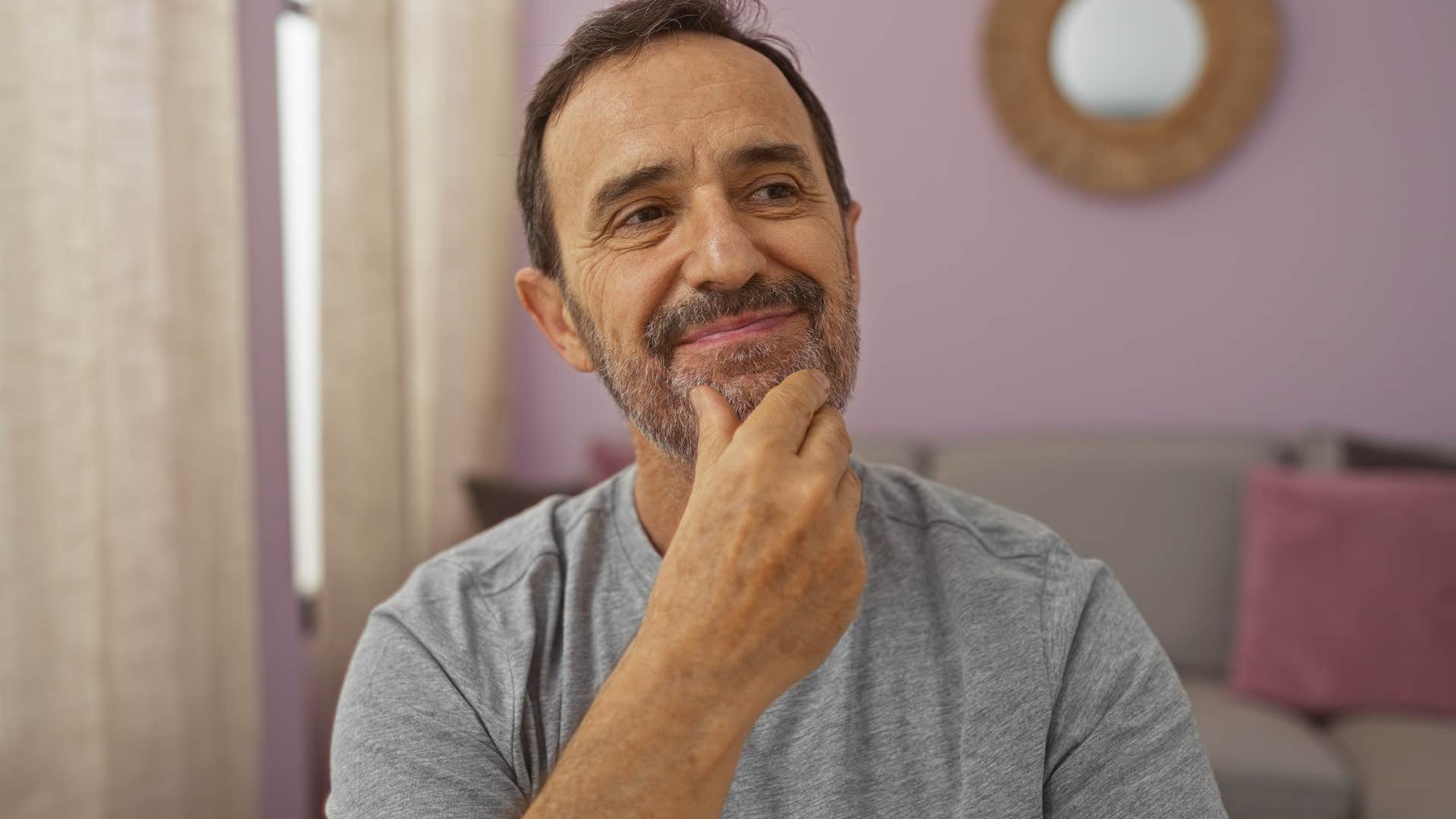 man who's observant around others sitting at home