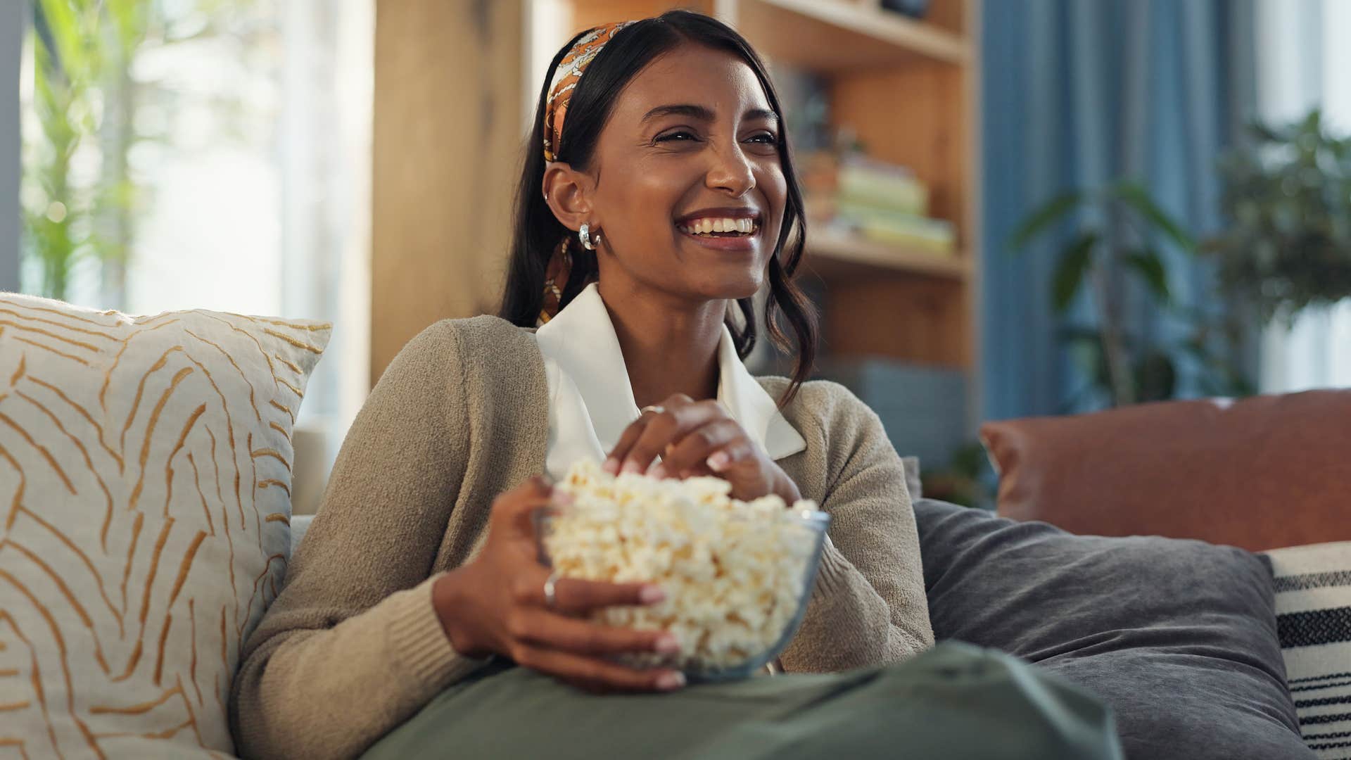 happy and intelligent woman rewatching comfort show cheers