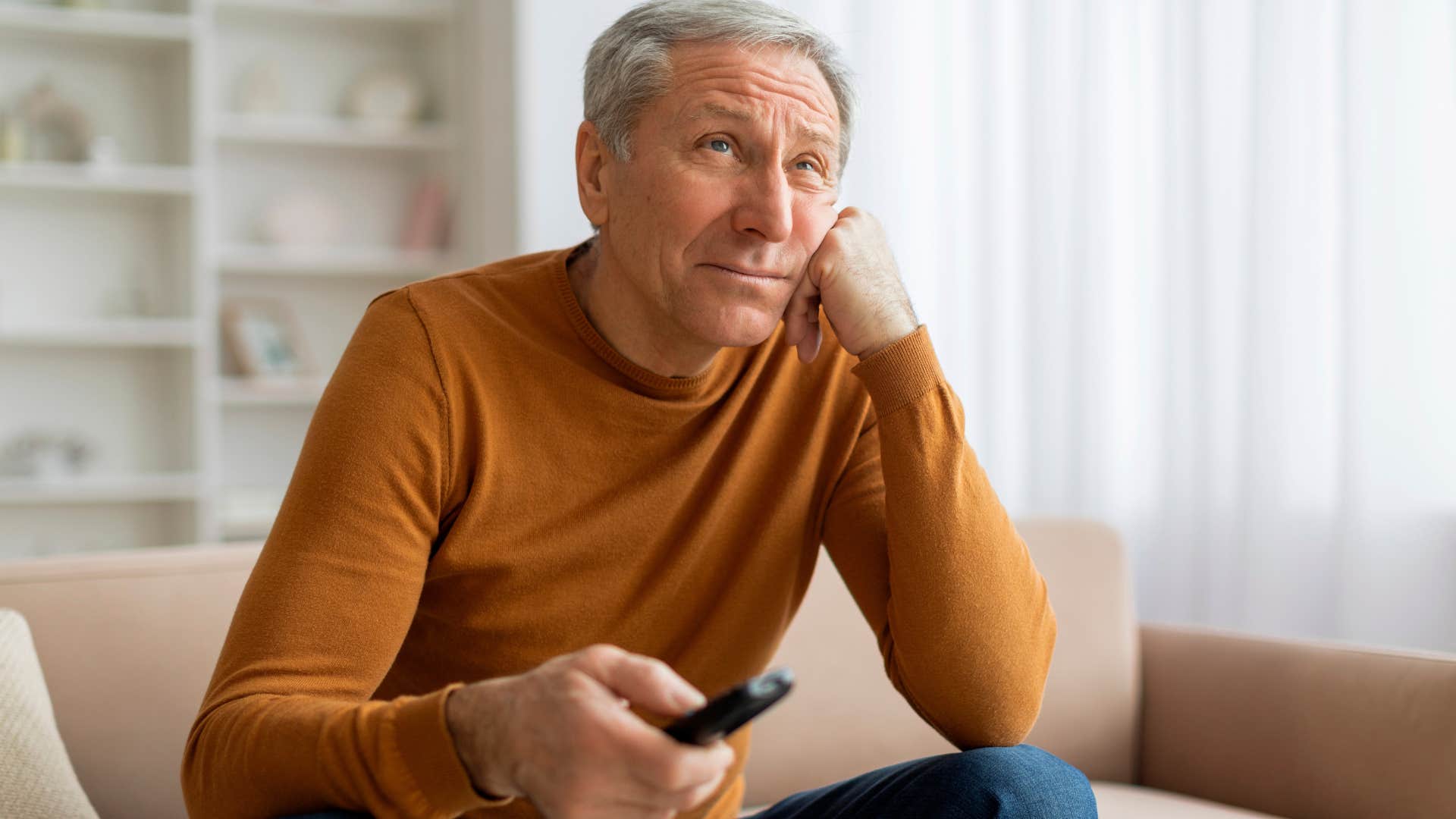 unusually intelligent man watching his comfort show 60 minutes on his couch