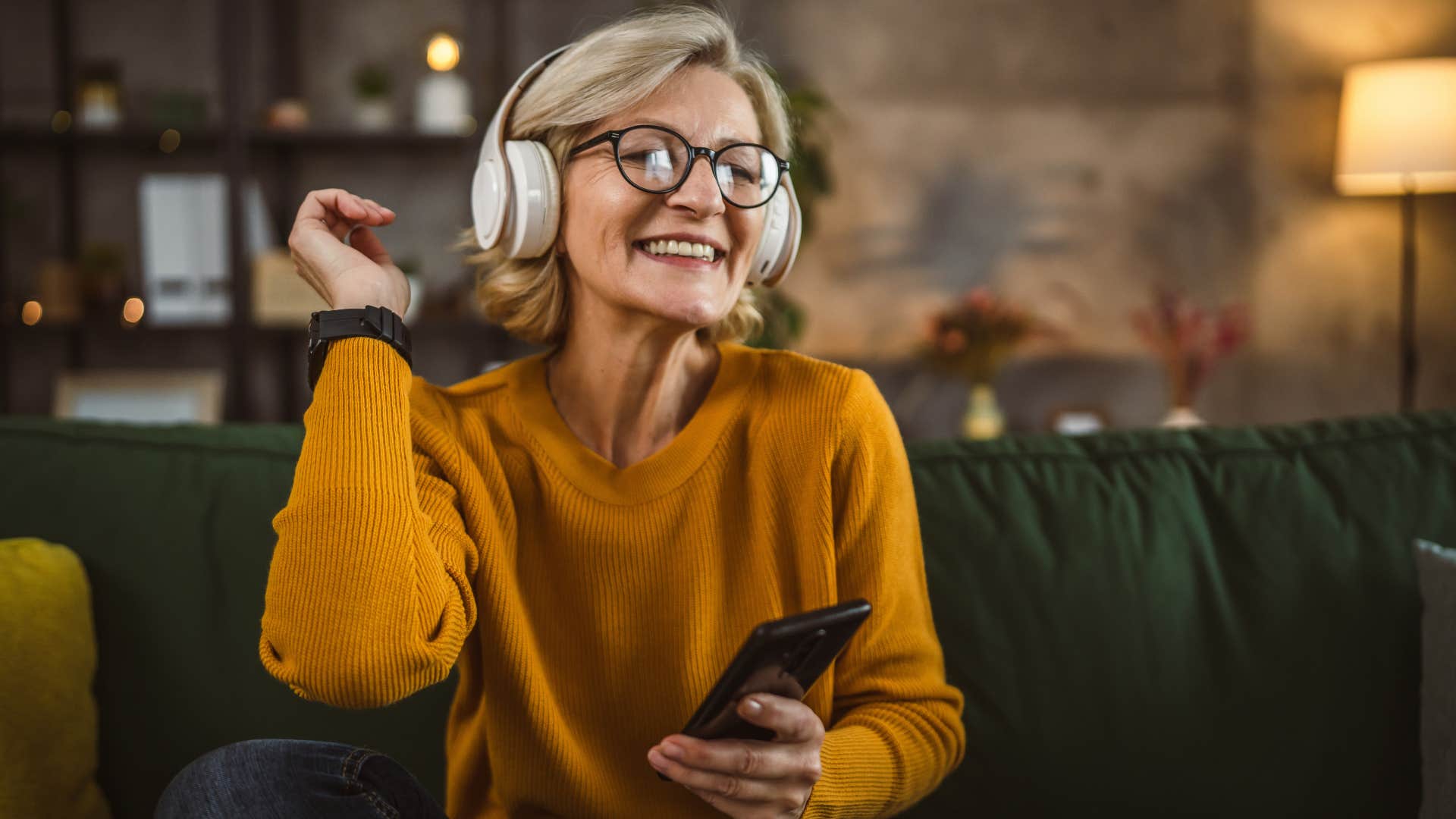 Happy person listens to music to stay positive after job loss