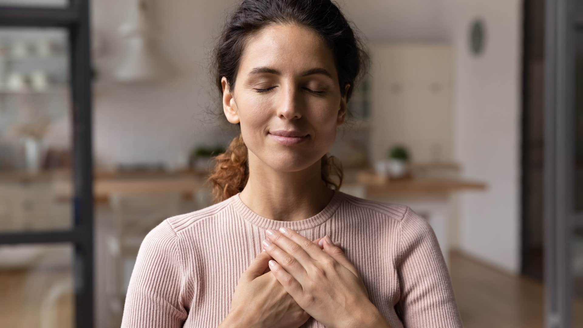 peacemaking woman meditating at home