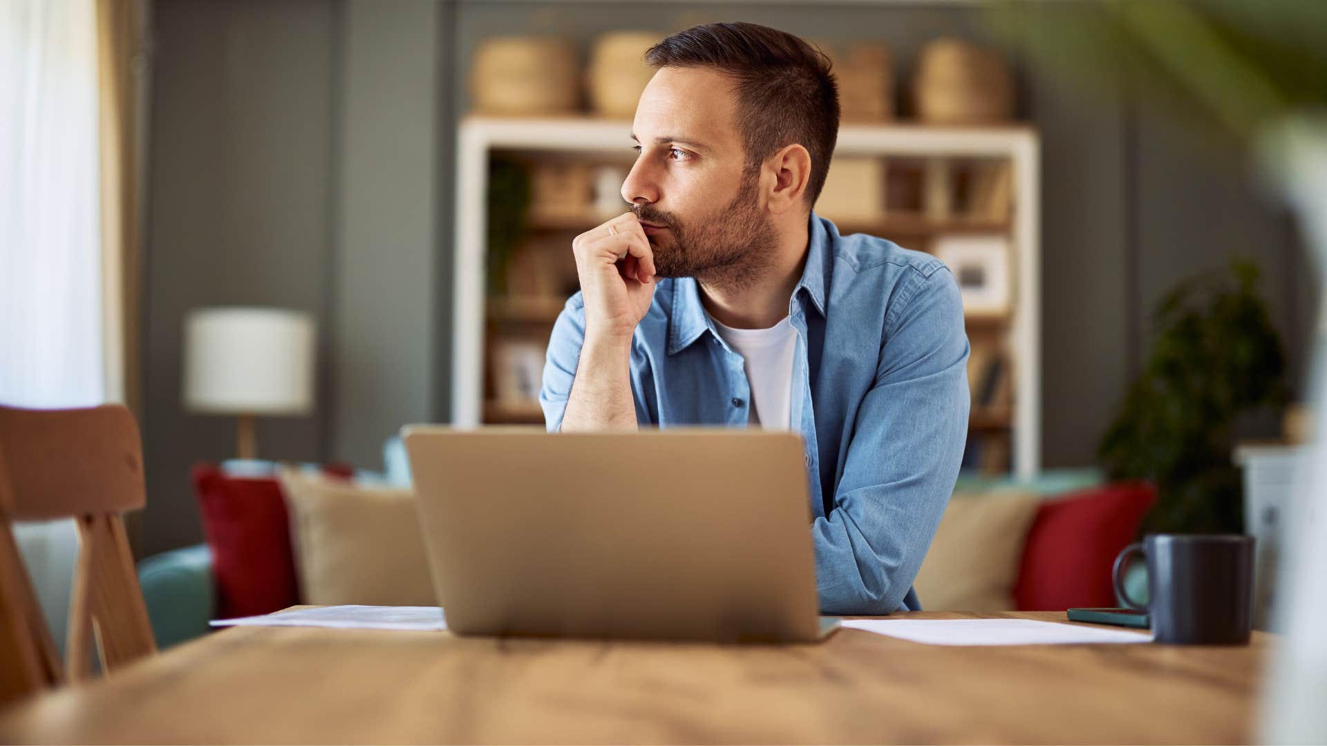 man in blue jacket thinking as he's highly curious