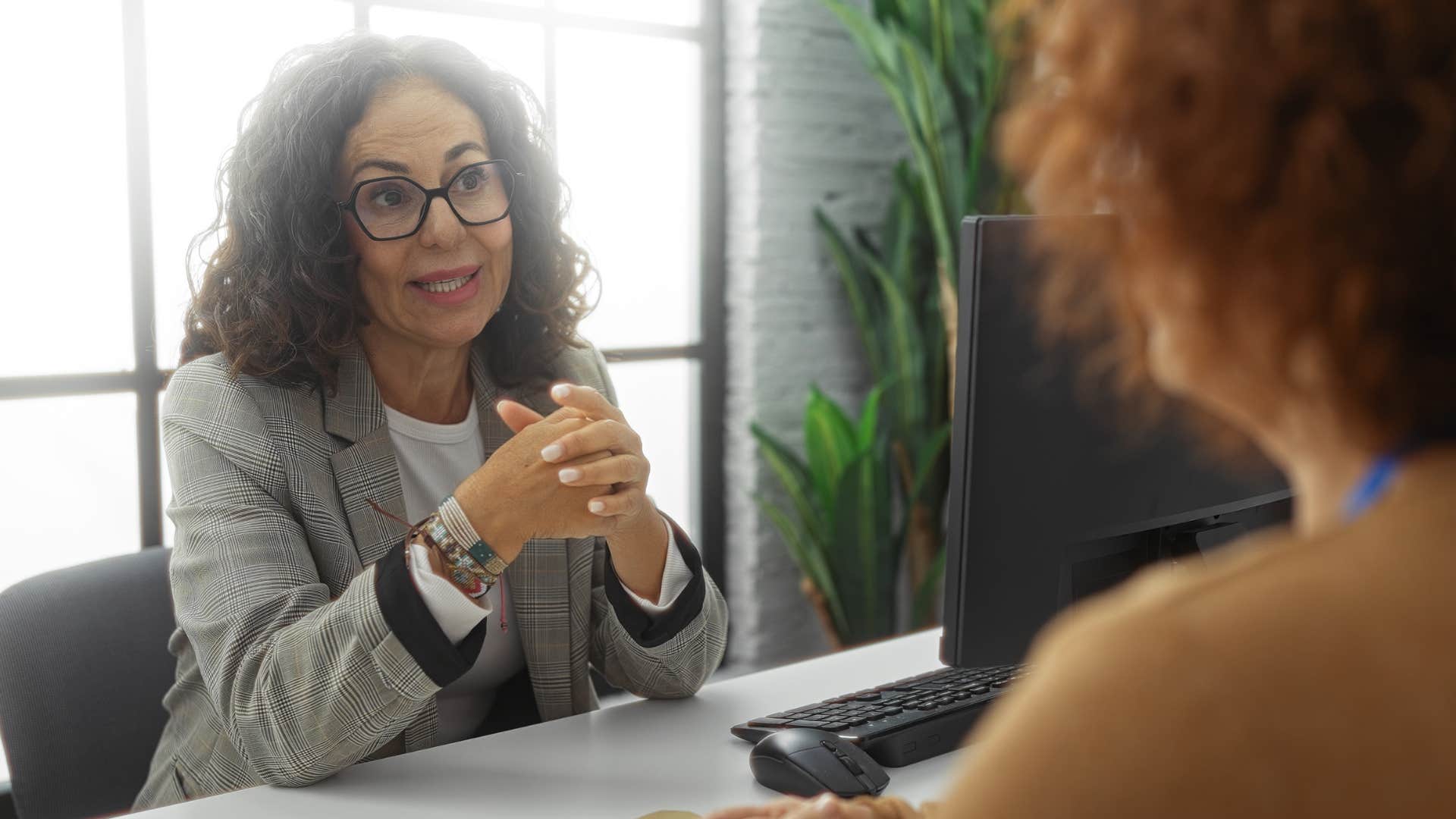 Woman saying "I don't agree, but I respect your opinion" to her co-worker.