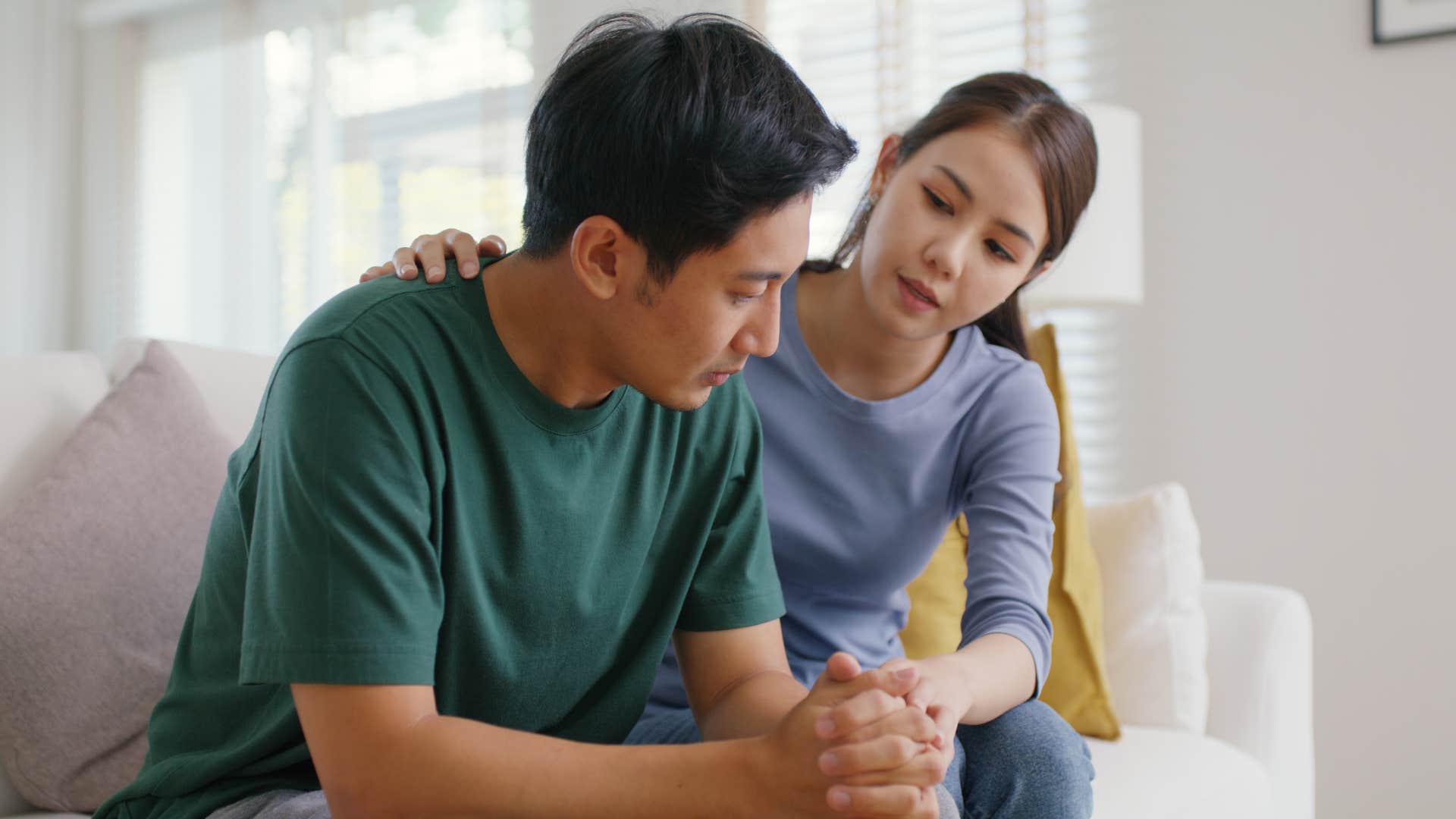 Woman saying "let's talk about it" to her upset partner.