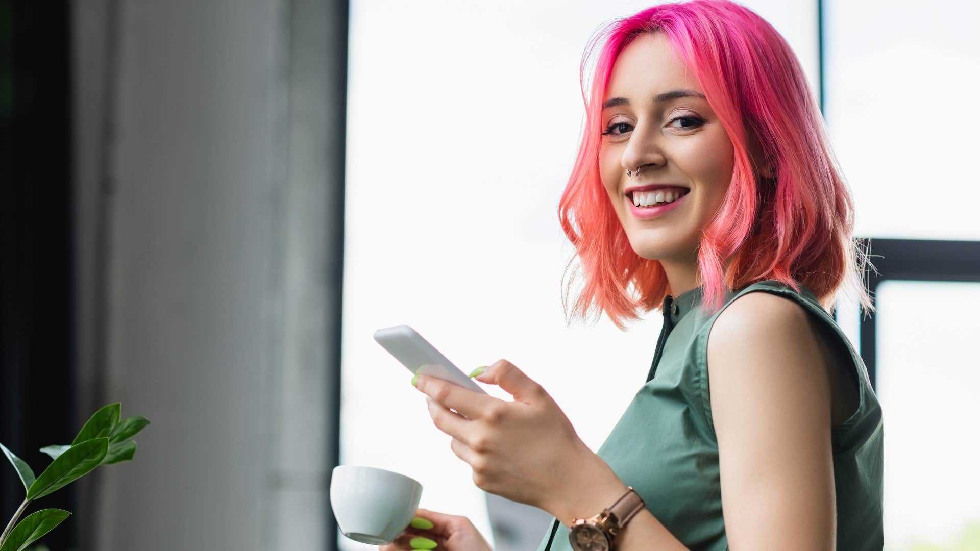 woman with pink hair who appreciates novelty and change smiling