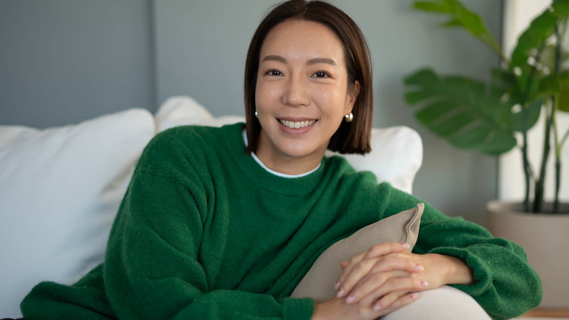 woman who needs alone time to recharge sitting on her couch