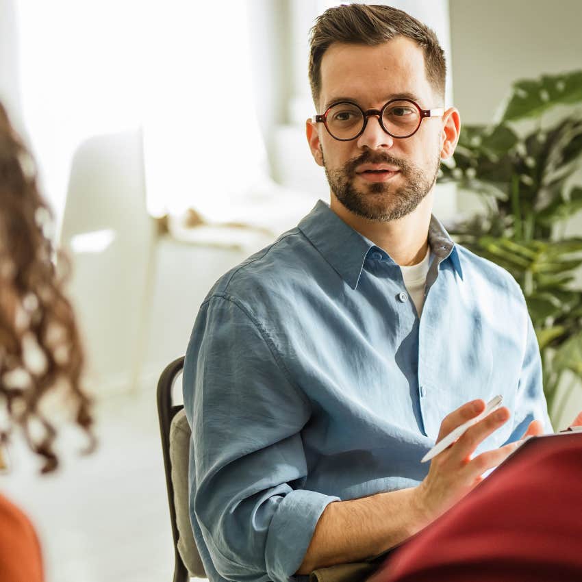 somewhat guarded man talking to a group of people he doesn't vibe with
