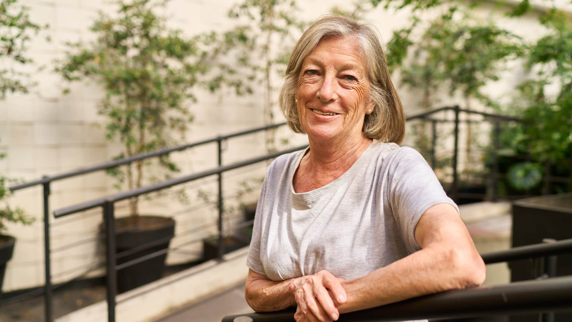 cheerful woman patiently standing outside