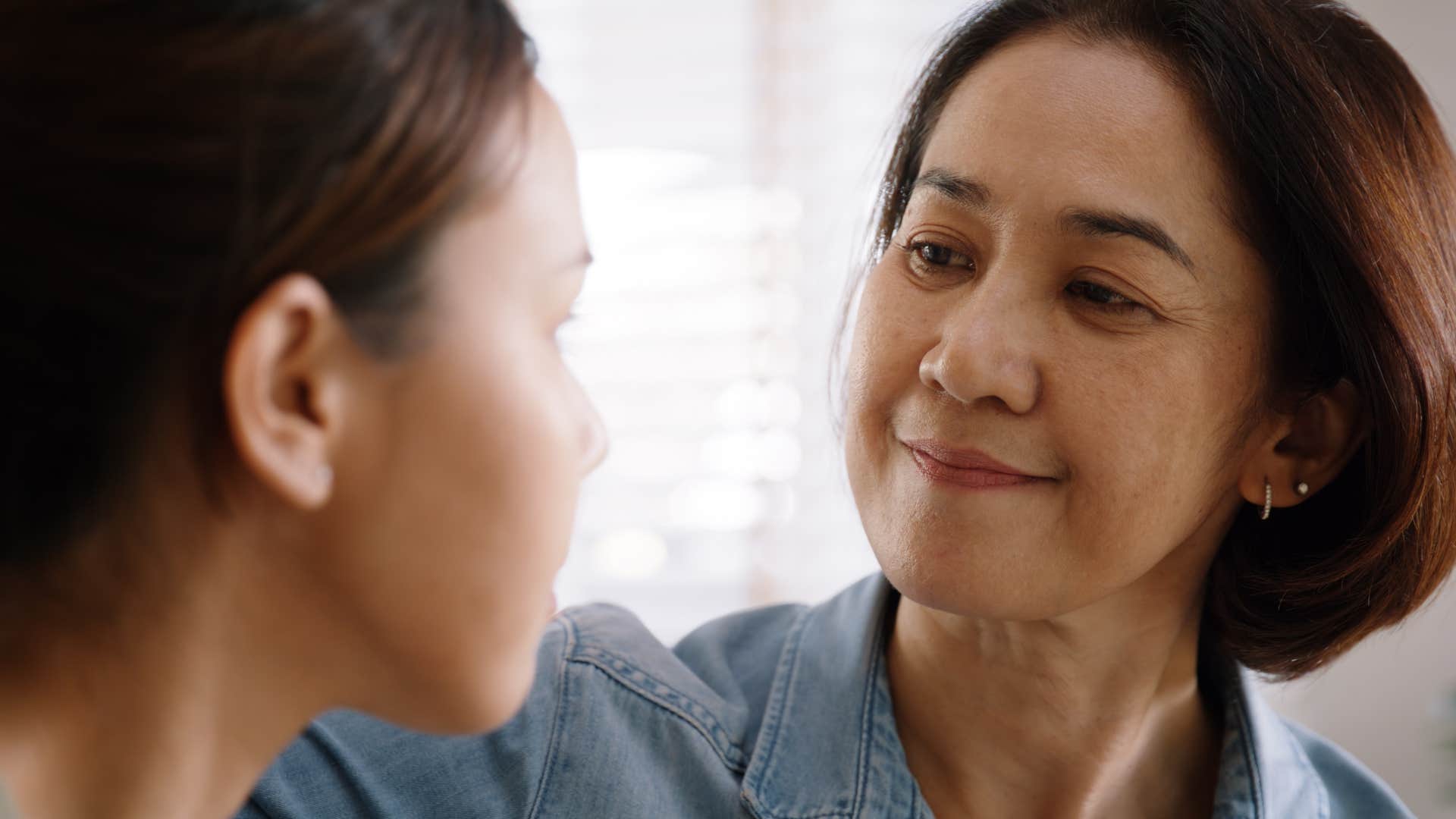 happy older person comforts younger person showing letting go of past