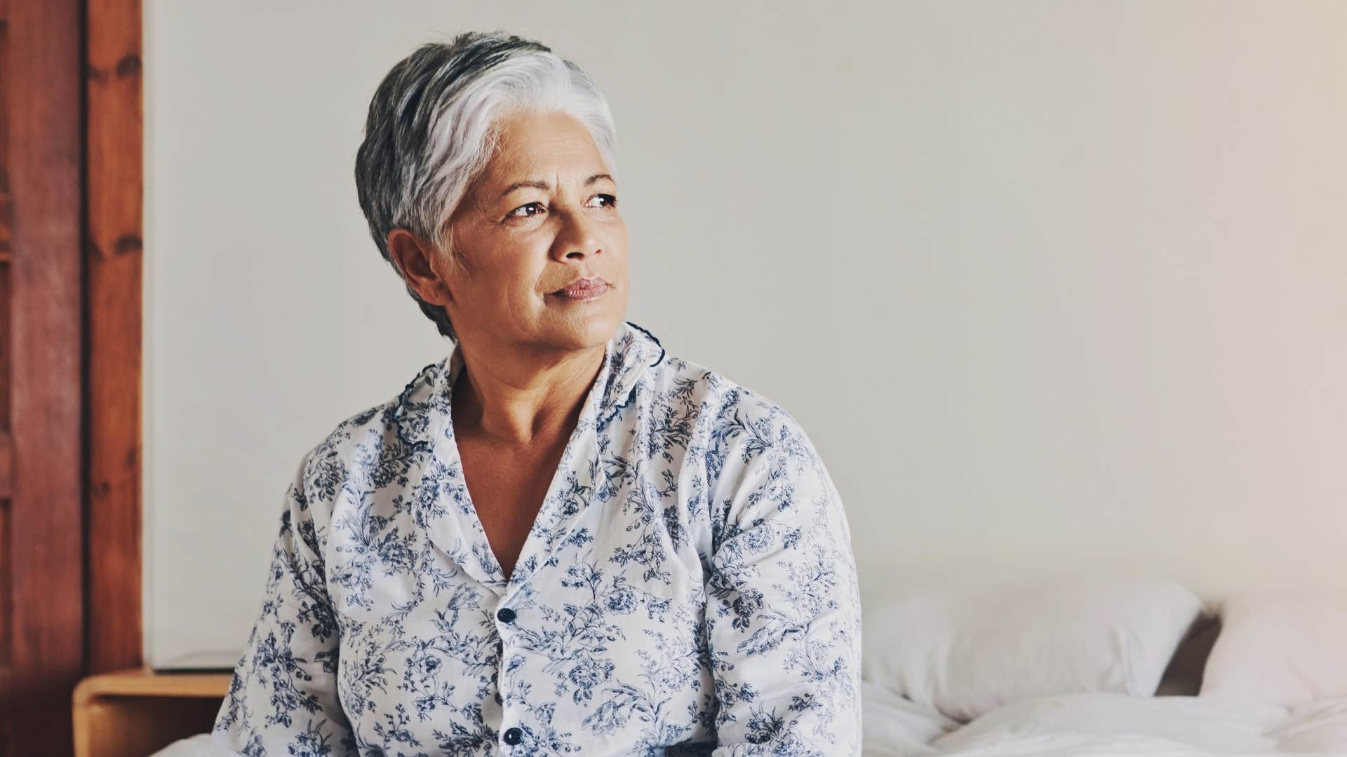 Serious older person wakes up showing they are realistic about aging 