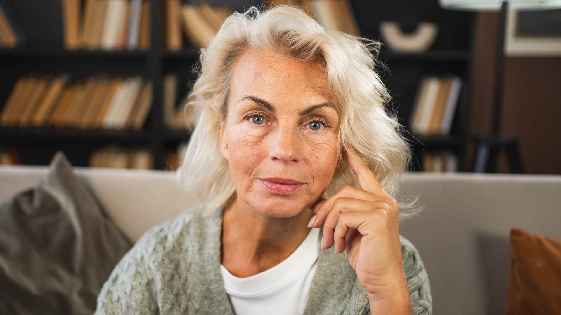 calm older person touches side of head showing importance of self-talk