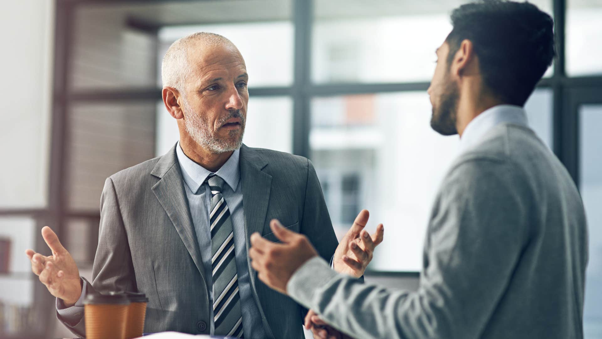 man telling his co-worker to stop making excuses at work