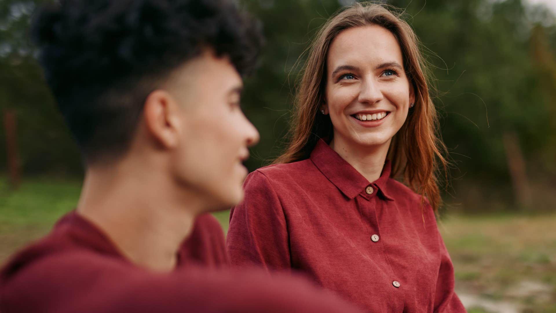 thoughtful woman smiling at friend at outdoor party