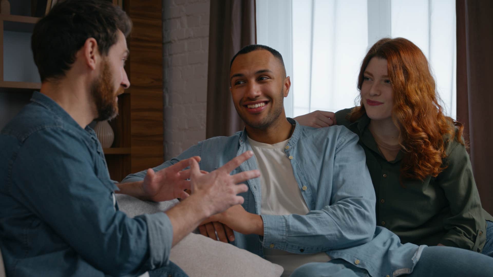 man who understands social energy and vibes sitting with friends at a party