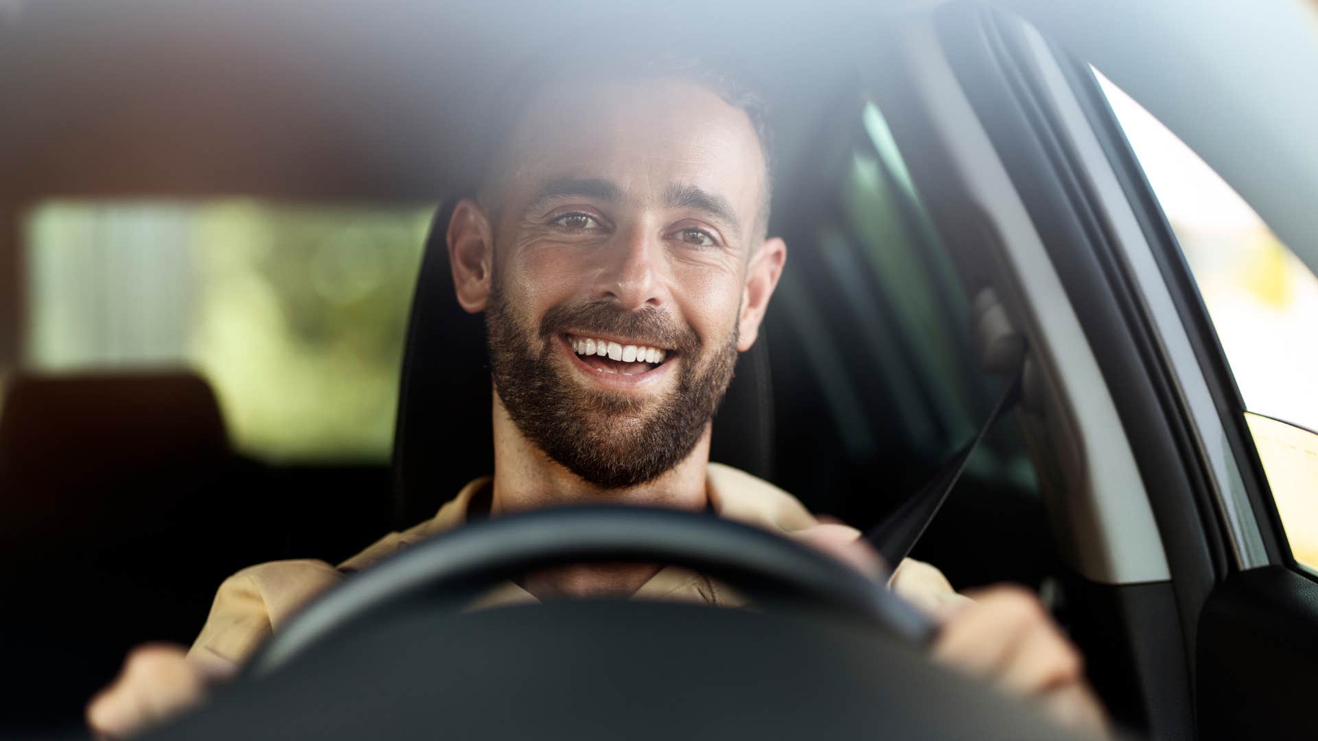 confident man letting other cars merge in traffic