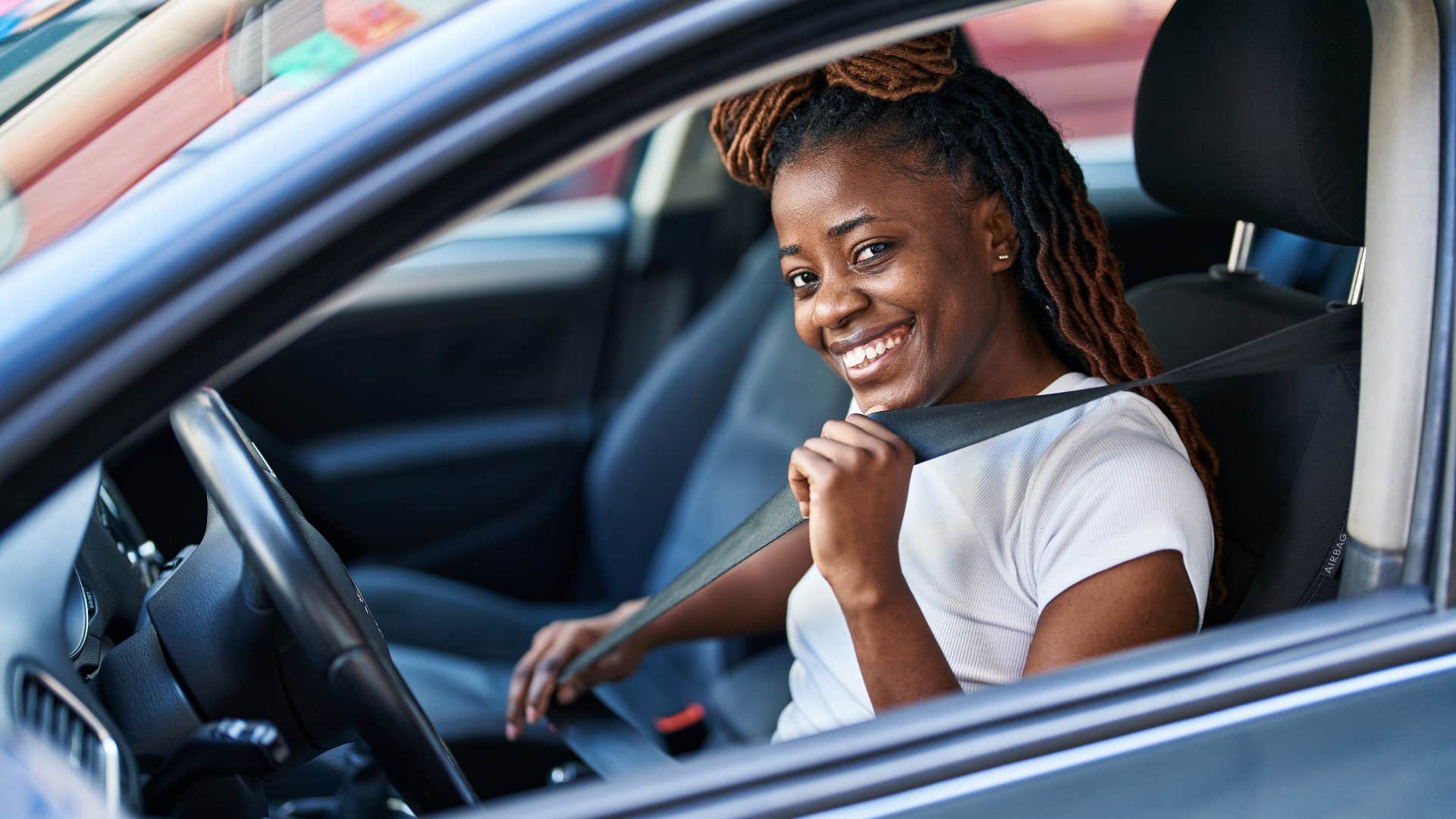 woman who leads with respect buckling her seatbelt
