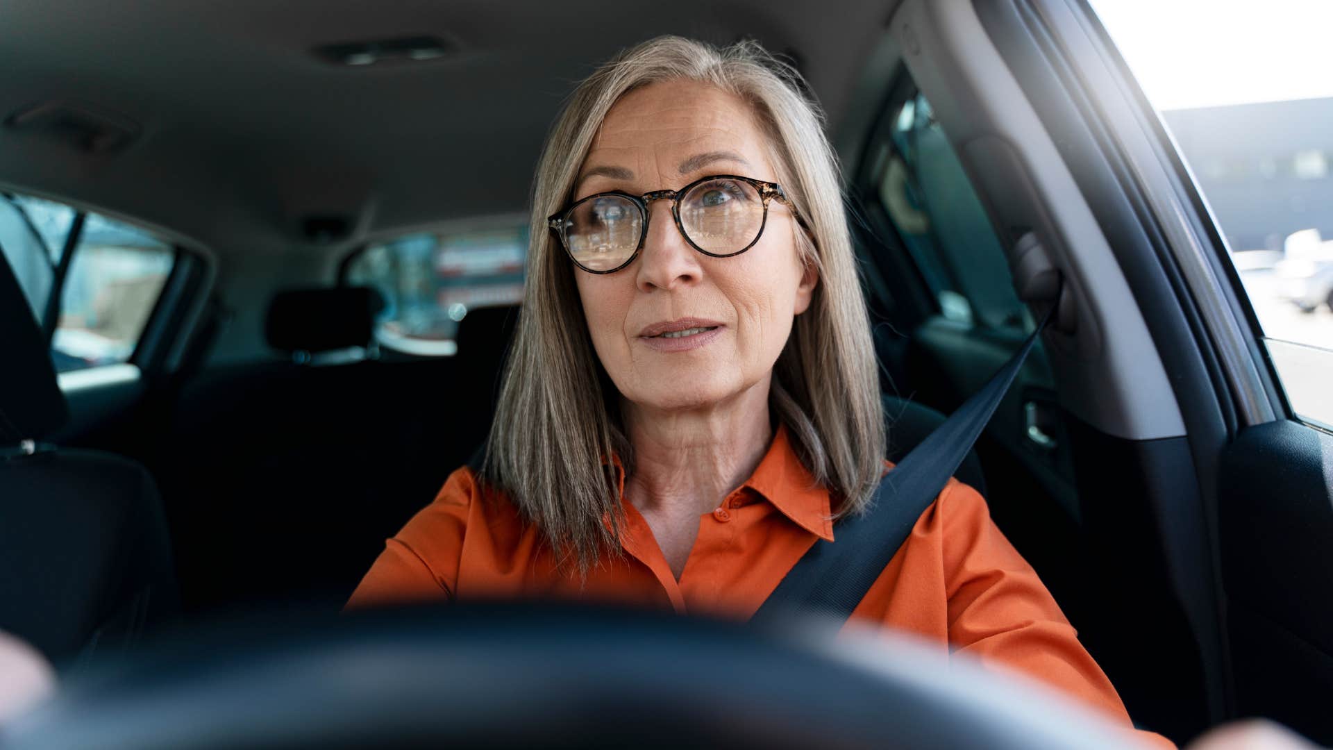 rule following woman letting other cars merge in traffic