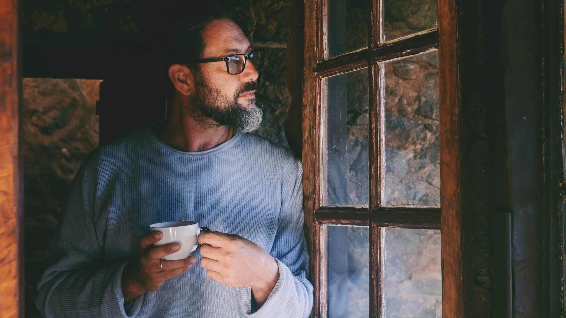 man living on autopilot staring outside