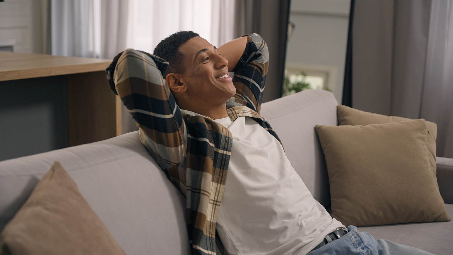 cozy man relaxing on his couch at home looking forward to bedtime