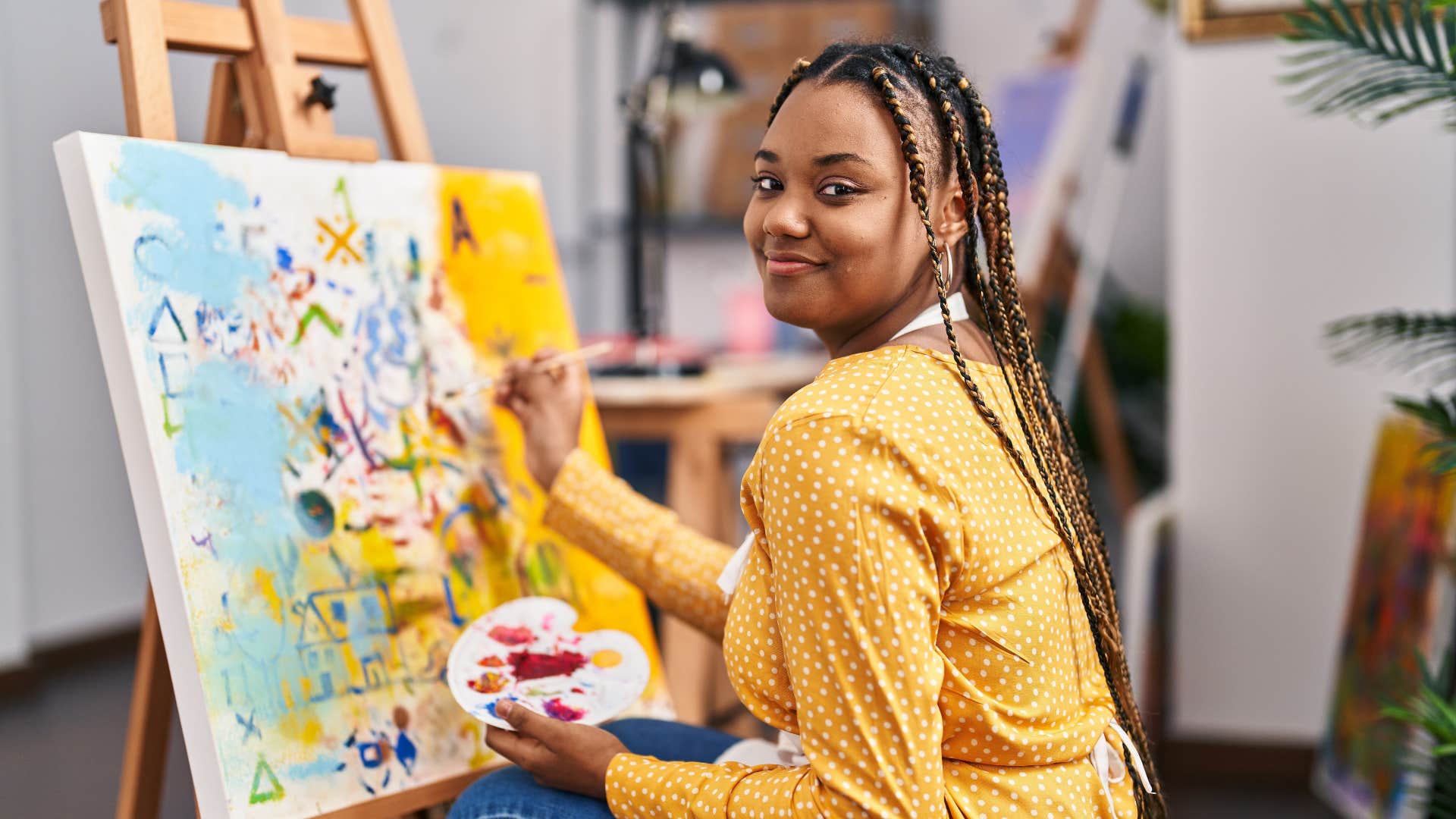 wildly creative woman painting smiling