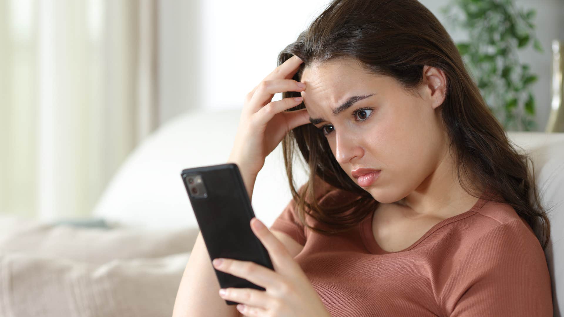 woman who's anxious about little things looking at her phone