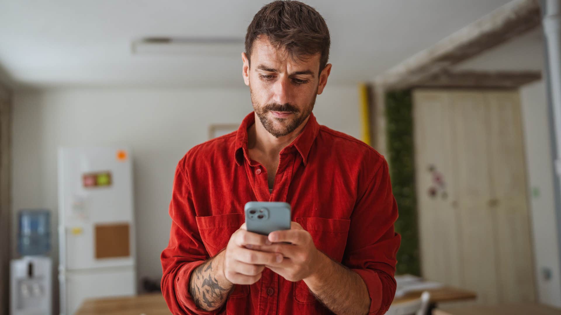 man who appreciates being in control looking at a restaurant menu on his phone