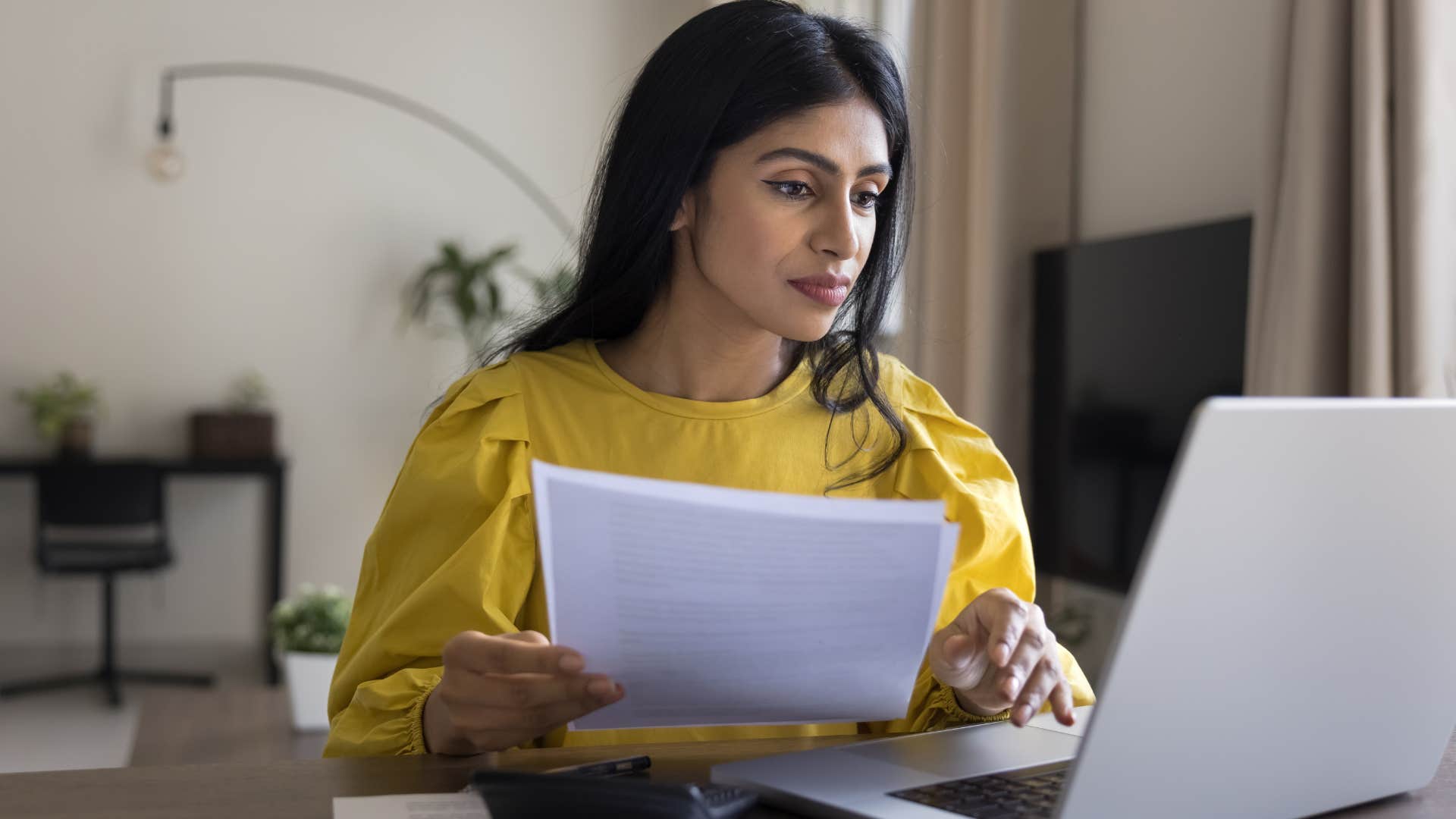 frugal woman doing bills at home