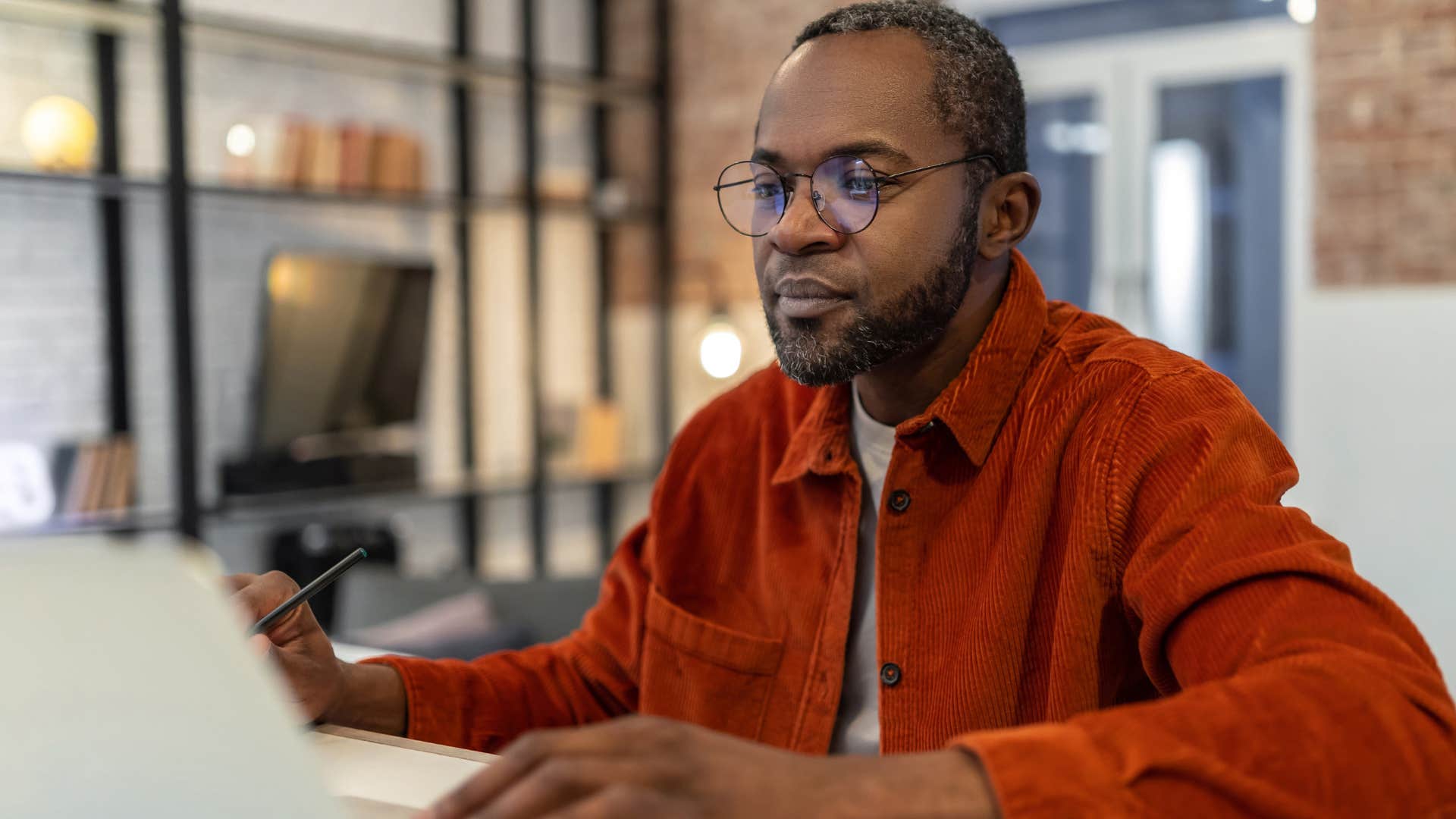 man who needs time to form an opinion looking at his laptop