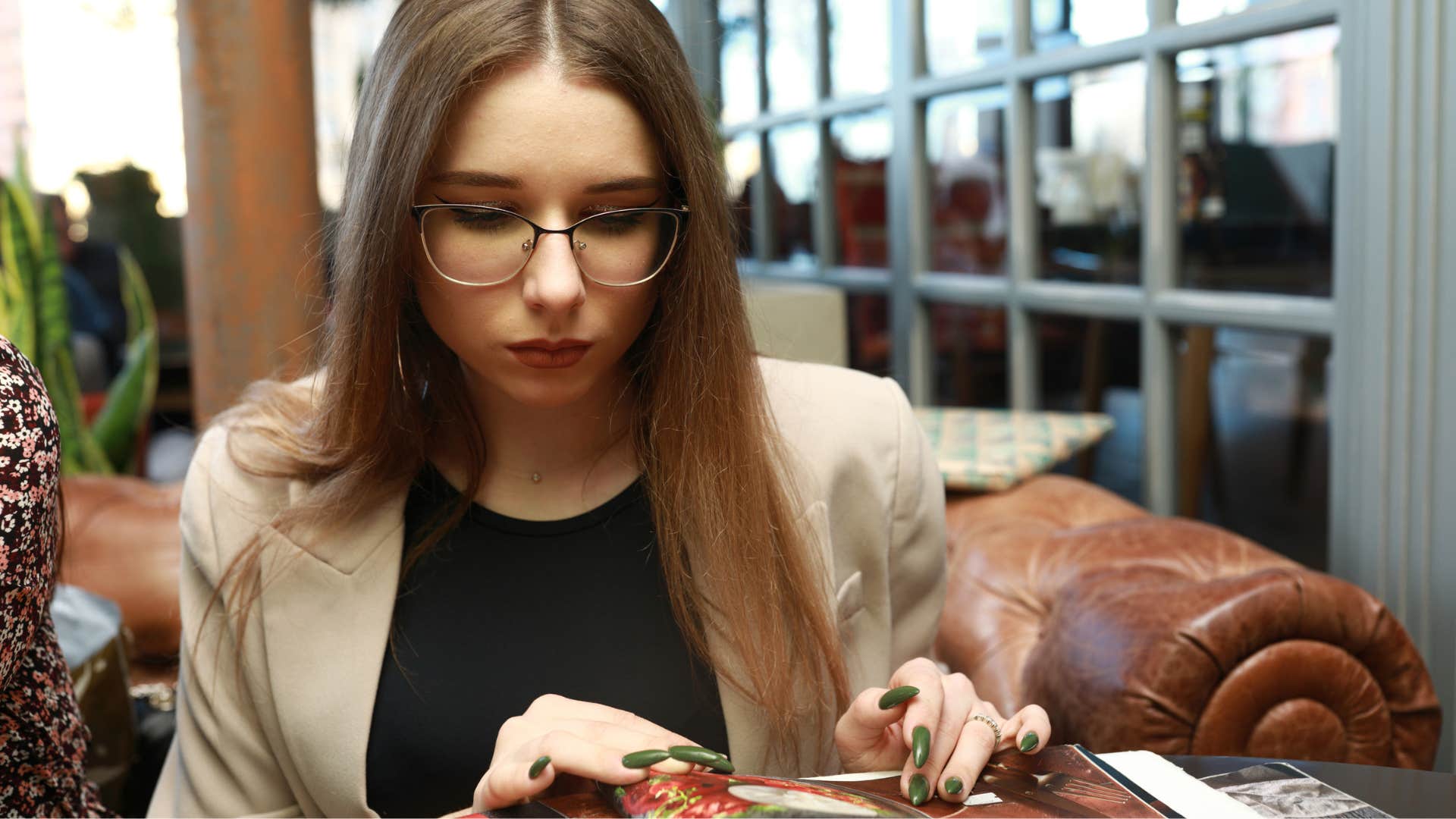 woman prone to decision paralysis looking at a menu