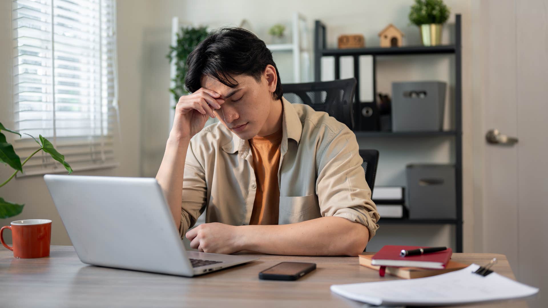 man feeling stressed sitting at desk