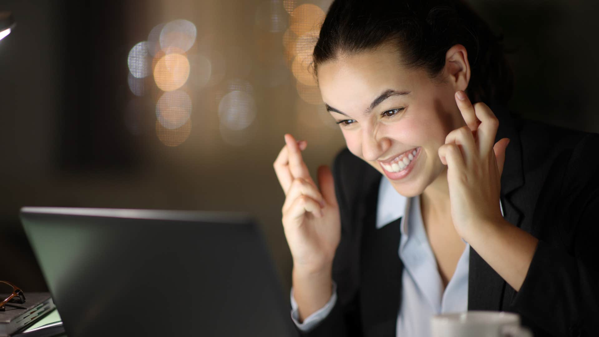 Excited person crosses fingers to visualize job interview success