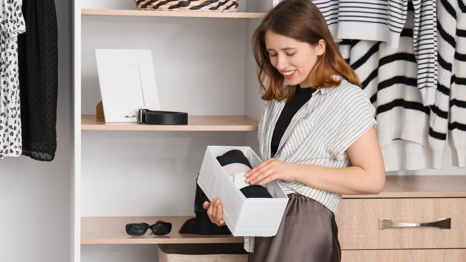woman organizing clothes in closet