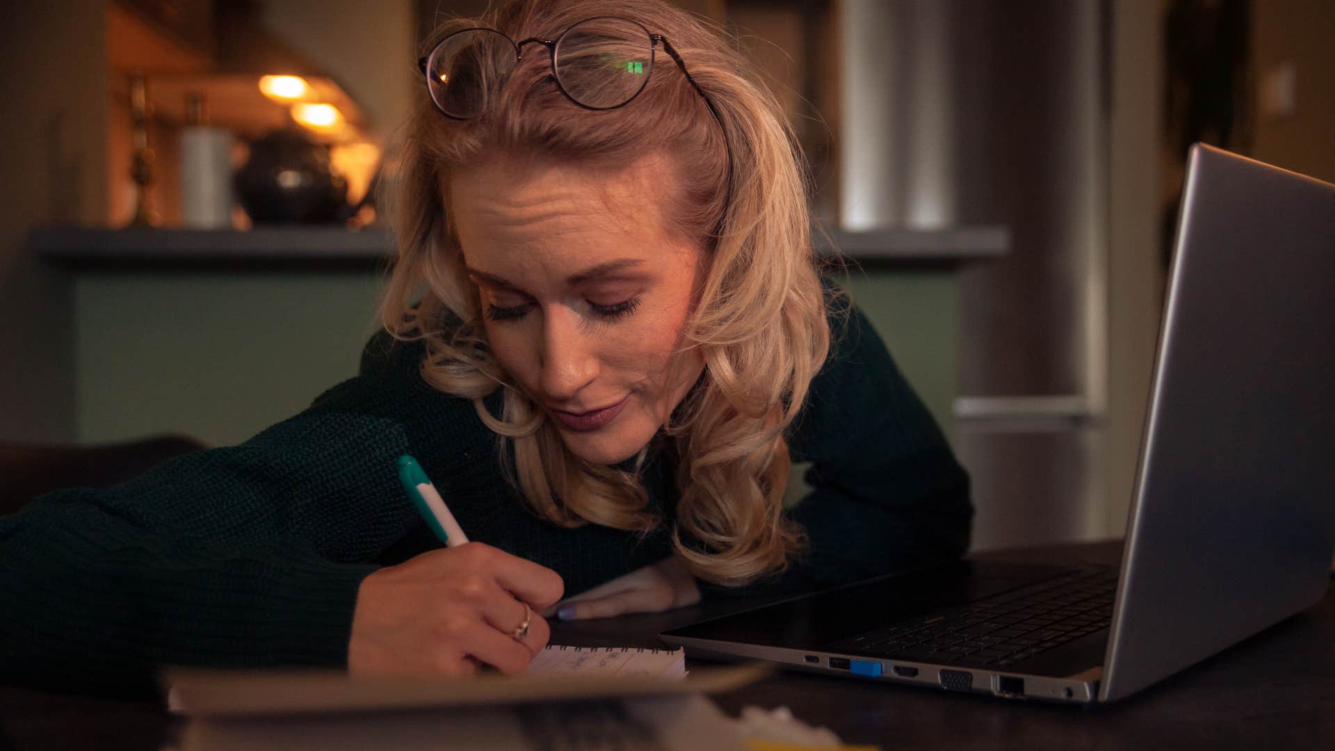 self-disciplined woman writing at night