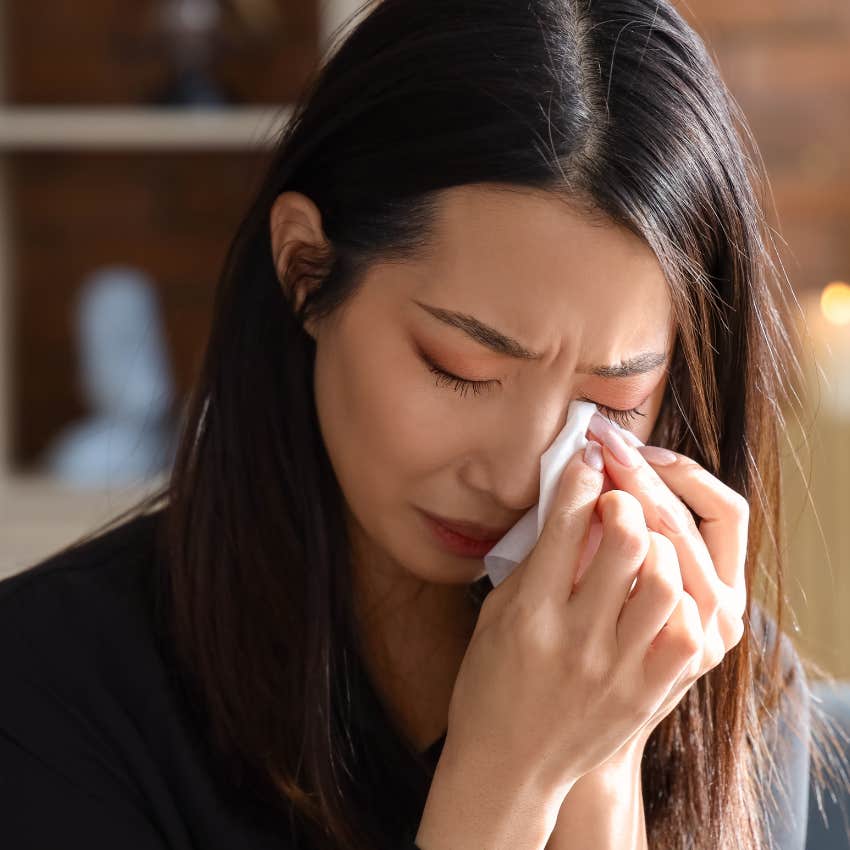 woman who has unresolved trauma crying