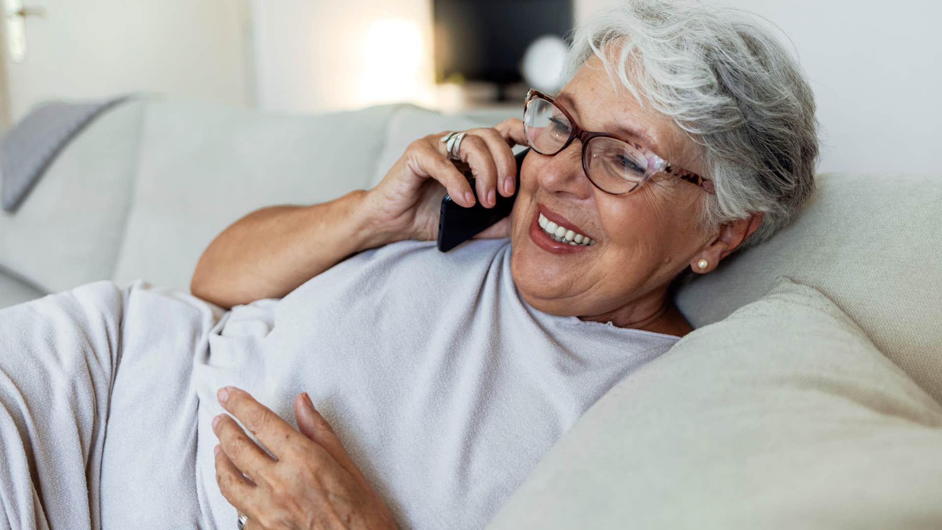 woman who doesn't chase trends and upgrades talking on the phone