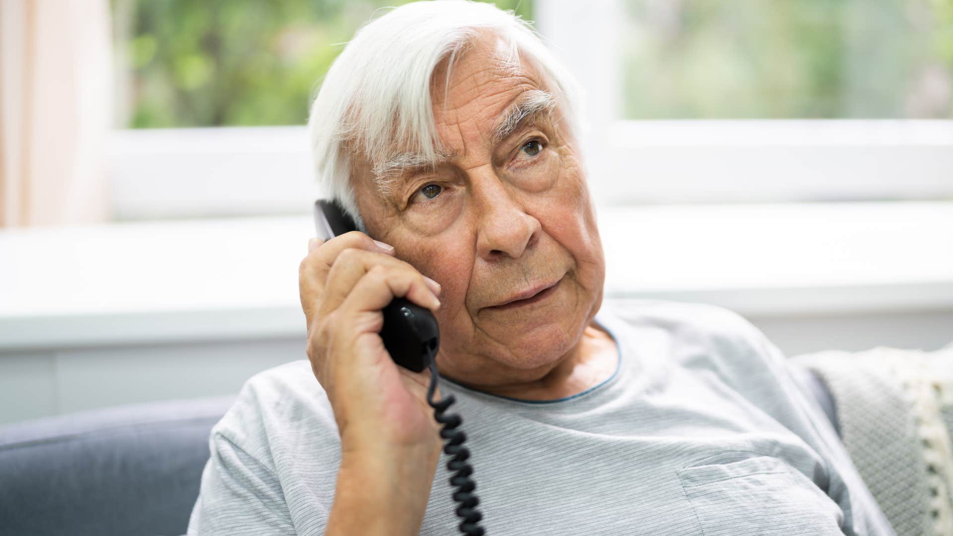 man who separates work and personal time talking on a landline