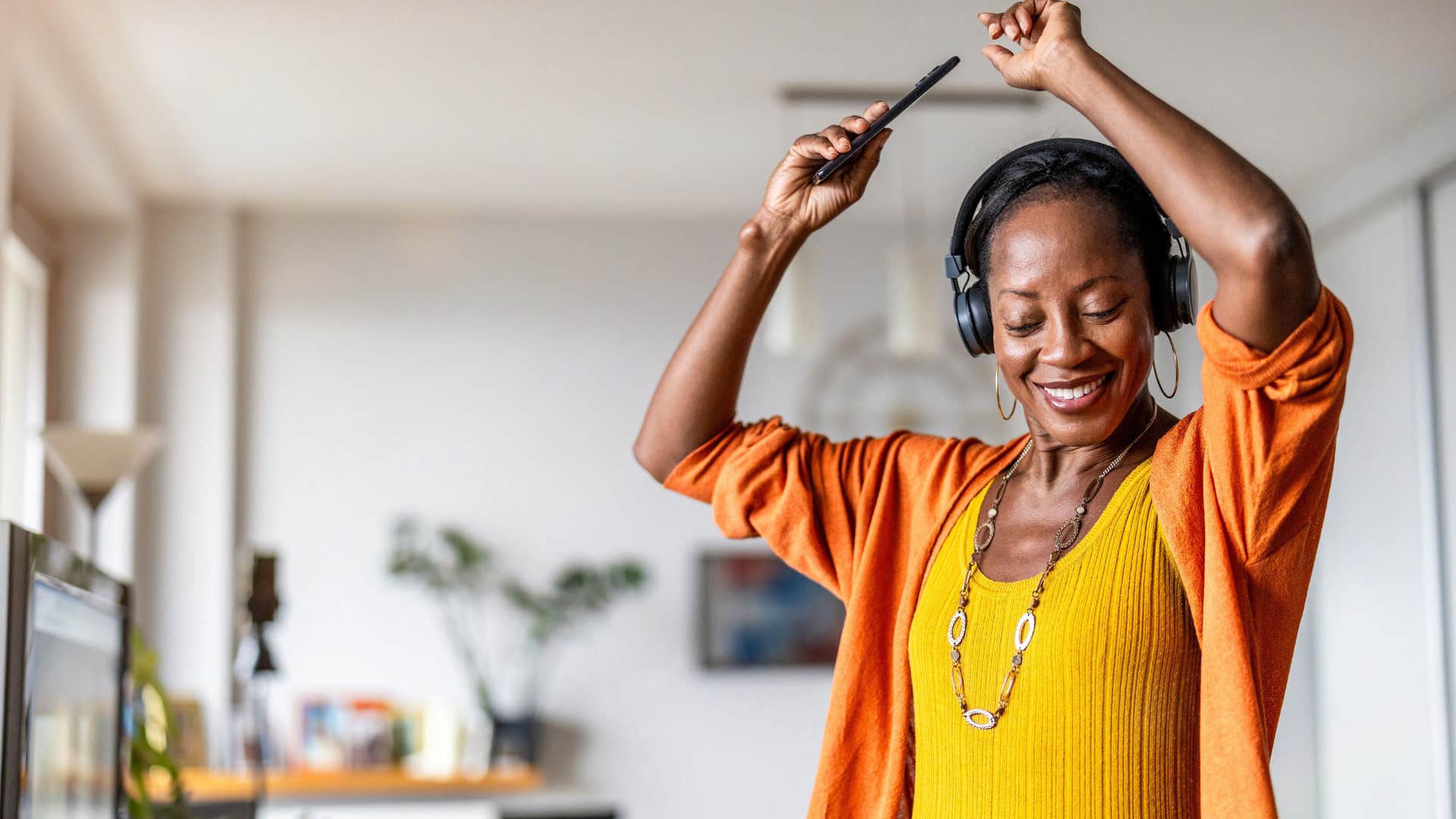 emotionally regulated woman dancing to music in her headphones
