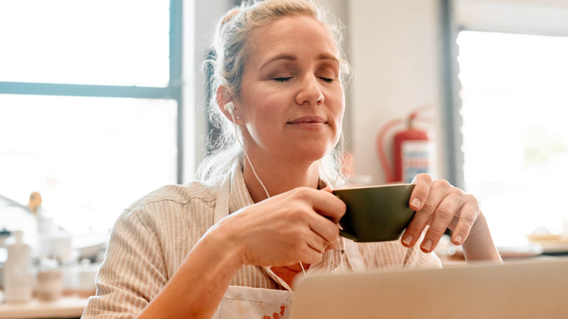 woman who feels obligated to overwork herself relaxing to music