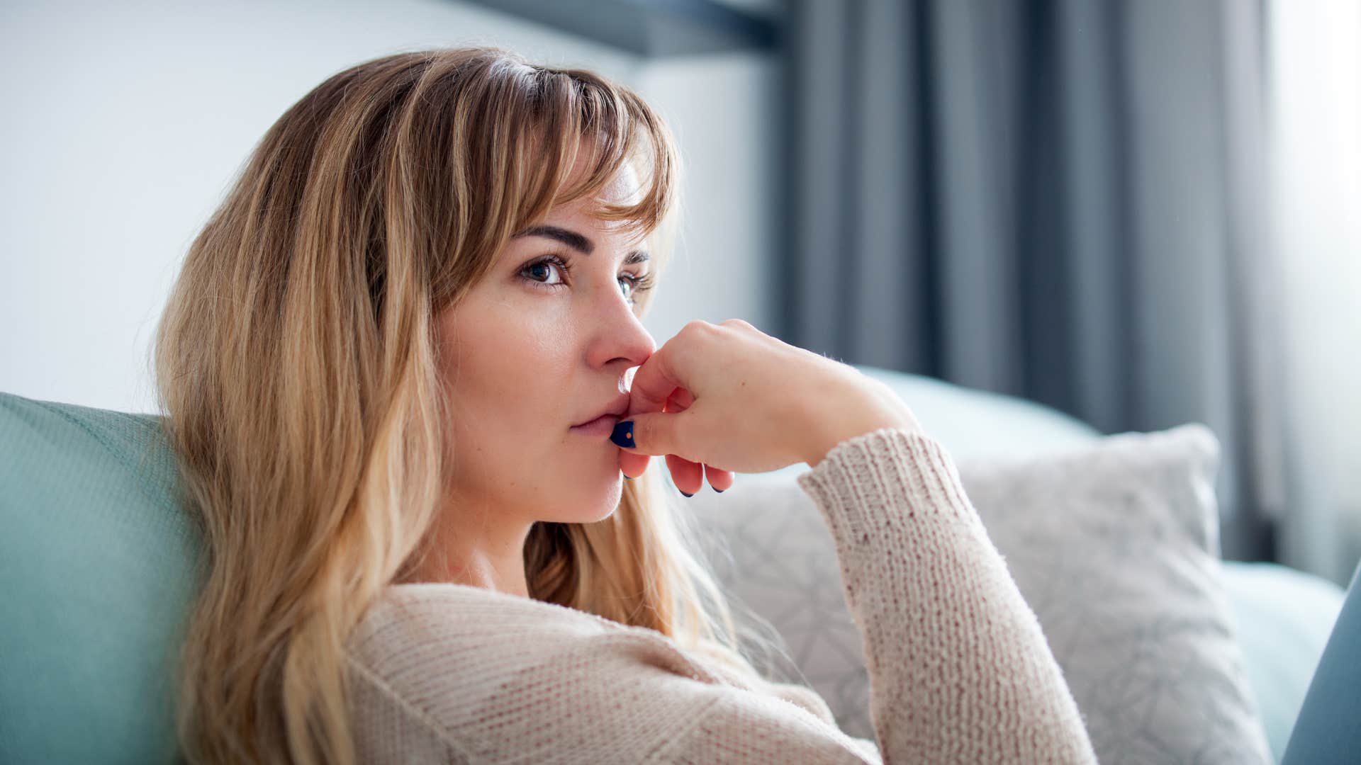deep thinking woman sitting at home